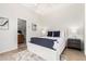Comfortable bedroom featuring a soft rug, king bed and ensuite bathroom at 42017 N Crooked Stick Rd, Anthem, AZ 85086