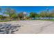 Community basketball court in outdoor recreational park, creating an inviting space for sports and activities on a sunny day at 42017 N Crooked Stick Rd, Anthem, AZ 85086