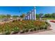 A beautiful community space with a vibrant flower bed surrounding a striking monument with benches nearby on a clear, sunny day at 42017 N Crooked Stick Rd, Anthem, AZ 85086