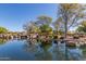 Scenic community pond reflecting the trees, shrubs, playground, and sky on a clear, sunny day at 42017 N Crooked Stick Rd, Anthem, AZ 85086