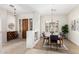 Open-concept living space featuring dining area and wood-look floors at 42017 N Crooked Stick Rd, Anthem, AZ 85086
