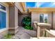 Charming entryway with stone path, mature greenery, and neutral stucco facade at 42017 N Crooked Stick Rd, Anthem, AZ 85086