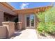 Inviting front entryway with desert plants, decorative iron railing and tiled walkway at 42017 N Crooked Stick Rd, Anthem, AZ 85086