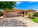Beautiful single-story home featuring a well-manicured front yard and an attached two-car garage at 42017 N Crooked Stick Rd, Anthem, AZ 85086