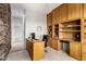 Home office with custom built-ins, desk, and stone accent wall at 42017 N Crooked Stick Rd, Anthem, AZ 85086