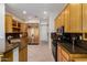 Spacious kitchen featuring custom wood cabinets, granite countertops, tile floors, and modern appliances at 42017 N Crooked Stick Rd, Anthem, AZ 85086