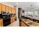 Bright kitchen with granite countertops, stainless steel appliances, and an open view to the living room at 42017 N Crooked Stick Rd, Anthem, AZ 85086