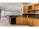 Kitchen area featuring custom cabinets, granite counters, an under mount sink and connection to the living area at 42017 N Crooked Stick Rd, Anthem, AZ 85086