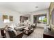 Bright living room boasts comfortable seating, a decorative rug and large window with outdoor views at 42017 N Crooked Stick Rd, Anthem, AZ 85086