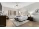 Spacious main bedroom features a plush bed, soft rug, and shuttered windows for natural light at 42017 N Crooked Stick Rd, Anthem, AZ 85086