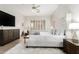 Bright main bedroom with hardwood floors, a soft rug, and upholstered bed at 42017 N Crooked Stick Rd, Anthem, AZ 85086