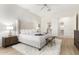 Spacious main bedroom with ensuite bathroom and a comfortable upholstered bed at 42017 N Crooked Stick Rd, Anthem, AZ 85086