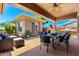 Inviting outdoor patio boasts comfortable seating, an outdoor kitchen, and lush landscaping at 42017 N Crooked Stick Rd, Anthem, AZ 85086