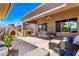 Spacious covered patio with BBQ and dining area overlooking the lush backyard at 42017 N Crooked Stick Rd, Anthem, AZ 85086