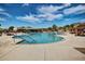 Community pool with clear blue water, surrounded by lounge chairs and desert landscaping under a sunny sky at 42017 N Crooked Stick Rd, Anthem, AZ 85086