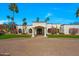 Charming desert home showcasing a front entrance with lush landscaping and a circular driveway at 4340 E Turquoise Ave, Phoenix, AZ 85028