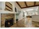 Open-concept living room with a stone fireplace and a seamless transition to the dining area at 4340 E Turquoise Ave, Phoenix, AZ 85028