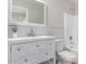 Updated bathroom with white vanity, hexagon tile, and bathtub at 4446 W Townley Ave, Glendale, AZ 85302