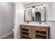 Double vanity bathroom with modern light fixtures and a light wood vanity at 4446 W Townley Ave, Glendale, AZ 85302