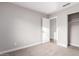 Well-lit bedroom with carpet flooring and closet at 4446 W Townley Ave, Glendale, AZ 85302