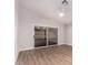 Bedroom with sliding glass doors and wood-look floors at 4446 W Townley Ave, Glendale, AZ 85302