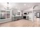 Open kitchen with gray cabinets, white backsplash, and a breakfast nook at 4446 W Townley Ave, Glendale, AZ 85302
