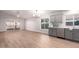 Bright kitchen with gray cabinets, white backsplash, and stainless steel appliances at 4446 W Townley Ave, Glendale, AZ 85302