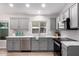 Newly renovated kitchen with gray cabinets and quartz countertops at 4446 W Townley Ave, Glendale, AZ 85302