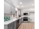 Modern kitchen boasts gray cabinets, quartz countertops, and stainless steel appliances at 4446 W Townley Ave, Glendale, AZ 85302