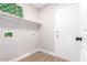 Laundry room with shelving and door to exterior at 4446 W Townley Ave, Glendale, AZ 85302