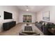 Spacious living area featuring a comfy sofa and large sliding glass doors at 4446 W Townley Ave, Glendale, AZ 85302