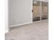 Spacious living room with gray carpeting and sliding glass doors to backyard at 4446 W Townley Ave, Glendale, AZ 85302