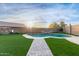 Inviting backyard oasis with a kidney-shaped pool and grassy area at 4446 W Townley Ave, Glendale, AZ 85302