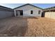 The back of the home includes a blank canvas back yard and covered patio at 47733 W Moeller Rd, Maricopa, AZ 85139