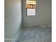 An unfinished bedroom with a window looking to a block wall at 47733 W Moeller Rd, Maricopa, AZ 85139