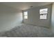 An unfinished bedroom with 2 windows at 47733 W Moeller Rd, Maricopa, AZ 85139