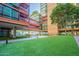 Modern building with a landscaped courtyard featuring artificial turf and seating at 4808 N 24Th St # 305, Phoenix, AZ 85016