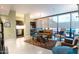 Open living area with leather sofa, large windows, and city views at 4808 N 24Th St # 305, Phoenix, AZ 85016