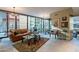 Open living area with leather sofa, large windows, and city views at 4808 N 24Th St # 305, Phoenix, AZ 85016