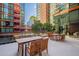 Relaxing patio area with wooden tables and chairs at 4808 N 24Th St # 305, Phoenix, AZ 85016