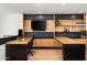 Modern home office with u-shaped wood desk and built-in shelving at 5419 E Valle Vista Rd, Phoenix, AZ 85018