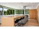 Modern kitchen with wood cabinets, large island, and leafy wallpaper at 5419 E Valle Vista Rd, Phoenix, AZ 85018