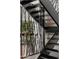 Modern staircase with black metal railing and glass panels at 5419 E Valle Vista Rd, Phoenix, AZ 85018