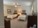 Guest bedroom with two twin beds and wood furniture at 5518 E Lindstrom Ln # 2004, Mesa, AZ 85215