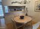 Bright dining area with a round table and four chairs, offering a view of the kitchen at 5518 E Lindstrom Ln # 2004, Mesa, AZ 85215