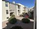 Building exterior showcasing a well-maintained courtyard with landscaping and walkways at 5518 E Lindstrom Ln # 2004, Mesa, AZ 85215
