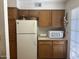 View of kitchen with wood cabinets and appliances at 5518 E Lindstrom Ln # 2004, Mesa, AZ 85215