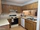 Kitchen features wood cabinets, electric stove, and dishwasher at 5518 E Lindstrom Ln # 2004, Mesa, AZ 85215