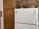Kitchen area with wood cabinets and white appliances at 5518 E Lindstrom Ln # 2004, Mesa, AZ 85215
