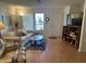 Bright living room with sofa, TV, and shelving unit, with a view to the outside at 5518 E Lindstrom Ln # 2004, Mesa, AZ 85215